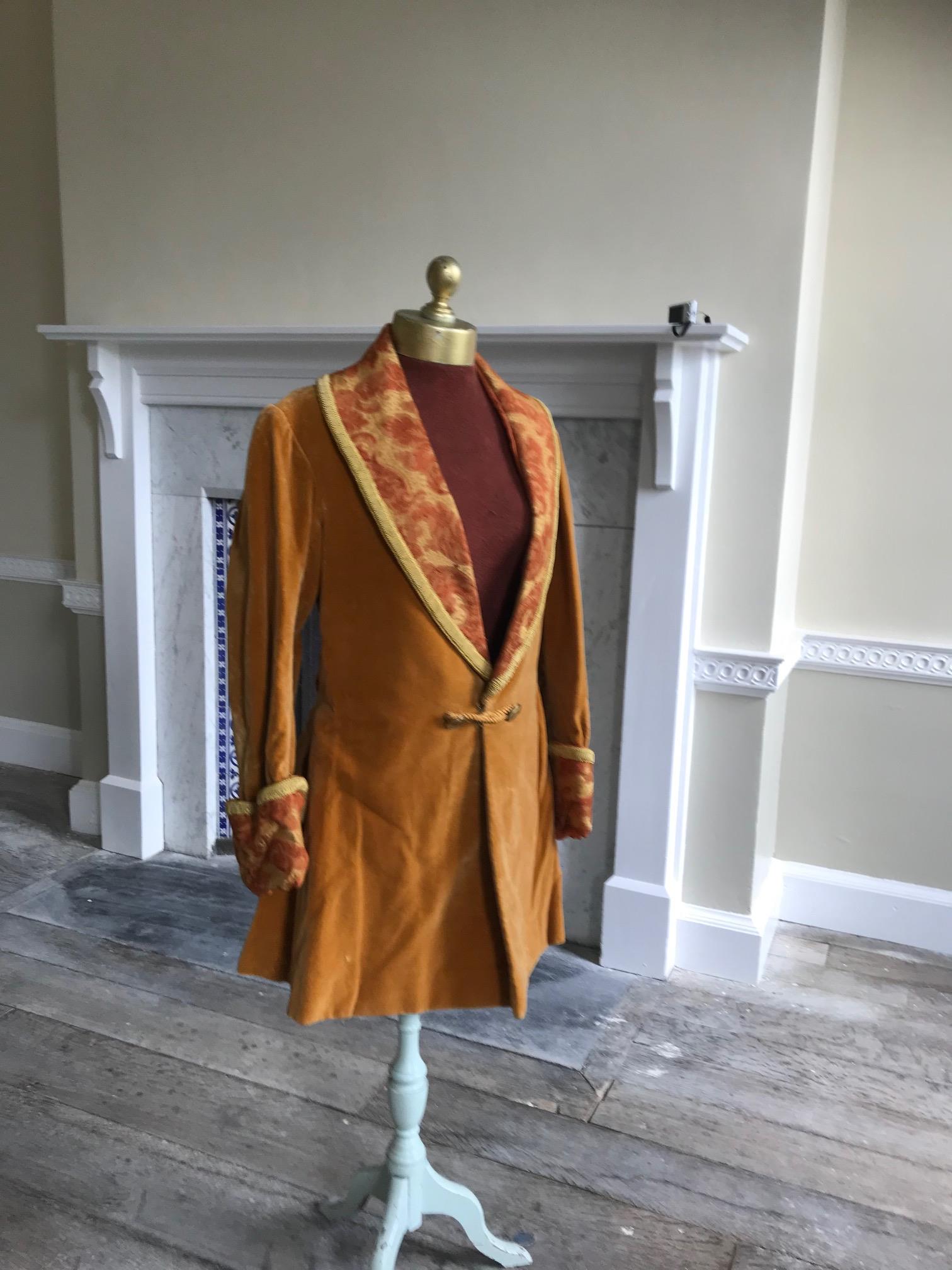 A man's 19th century smoking jacket, mustard velvet, with brocade lapels and cuffs. Ex Royal Opera House 'Arabella'